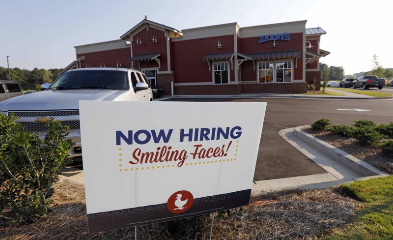 This July 25, 2018, file photo shows a help wanted sign at a new Zaxby's restaurant in Madison, Miss. (AP Photo/Rogelio V. Solis, File)