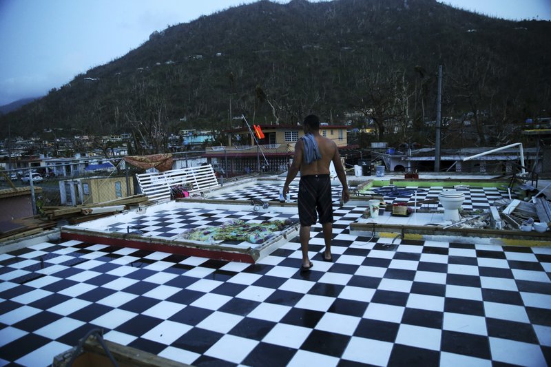  In this Sept. 26, 2017 file photo, Nestor Serrano walks on the upstairs floor of his home, where the walls were blown off, in the aftermath of Hurricane Maria, in Yabucoa, Puerto Rico. More than a year after Hurricane Maria caught Puerto Rico's government wildly unprepared, officials acknowledge they still haven't come up with a plan to cope with the next such disaster and it's not clear when they will. (AP Photo/Gerald Herbert, File)