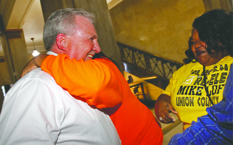 LaTawand Evans, right, smiles as Union County Judge Mike Loftin gets a hug from supporters at the courthouse as results are called out. Loftin won his re-election bid Tuesday night.