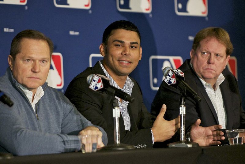 Agent Scott Boras, left, is shown with Carlos Pena, center, and Chicago Cubs Vice President and General Manager Jim Hendry in this file photo.