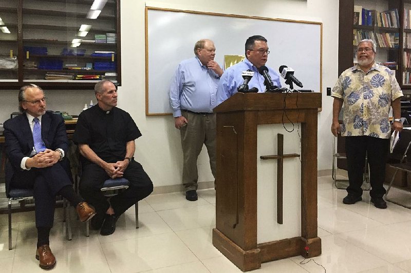Church lawyer Keith Talbot speaks Wednesday in Hagatna, Guam, where the Catholic Church announced that it will file for bankruptcy.