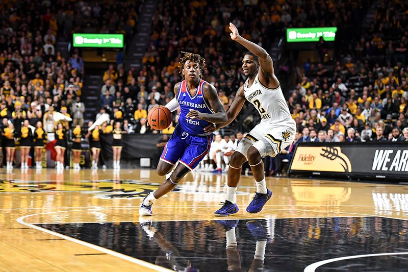 Submitted photo DUAL SHOCK: Louisiana Tech guard Amorie Archibald, left, dribbles down the lane against Wichita State guard Jamarius Burton (2) Tuesday during the Bulldogs' 71-58 victory over the Shockers at the Charles Koch Arena in Wichita, Kansas. Photo by Kelly Ross, courtesy of Louisiana Tech Communications.