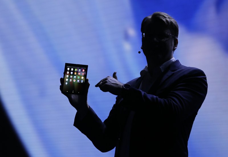 Justin Denison, SVP of Mobile Product Development, shows off the Infinity Flex Display of a folding smartphone during the keynote address of the Samsung Developer Conference Wednesday, Nov. 7, 2018, in San Francisco. (AP Photo/Eric Risberg)