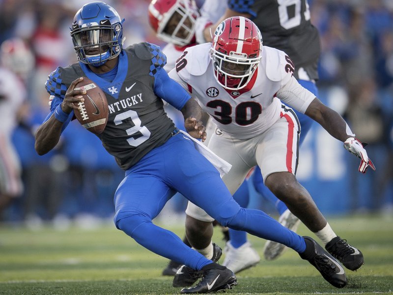 In this Saturday, Nov. 3, 2018, file photo, Georgia linebacker Tae Crowder (30) pressures Kentucky quarterback Terry Wilson (3) during the second half an NCAA college football game against in Lexington, Ky.  (AP Photo/Bryan Woolston, File)