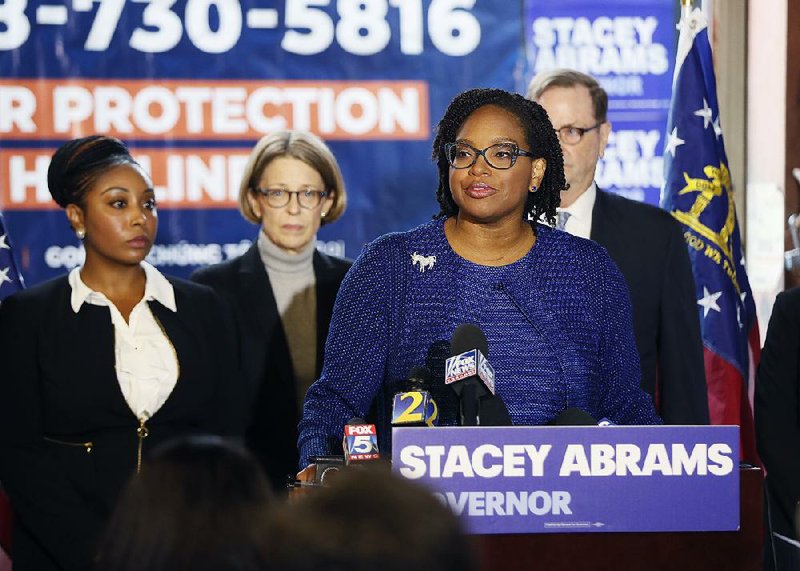 Allegra Lawrence-Hardy, campaign chairman for Georgia gubernatorial candidate Stacey Abrams, and the campaign’s attorneys said at a news conference Thursday in Atlanta that they would continue fighting to make sure all ballots are counted, insisting that there are enough to affect the outcome of the race. GOP candidate Brian Kemp resigned Thursday as Georgia’s secretary of state, a day after his campaign said he had enough votes to win. 