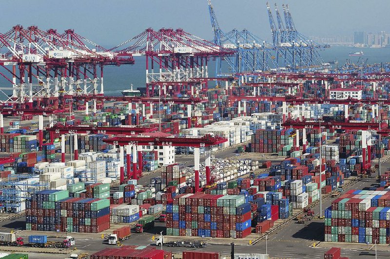 Containers sit piled high Thursday at a port in Qingdao, China. China’s export growth accelerated in October as companies rushed out shipments before new U.S. tariff rates kick in. 