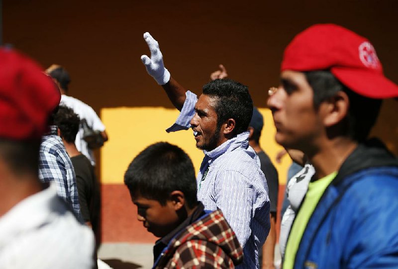 Central American migrants march Thursday to a United Nations human-rights office in Mexico City to make their case for buses to carry them to the U.S. border. 