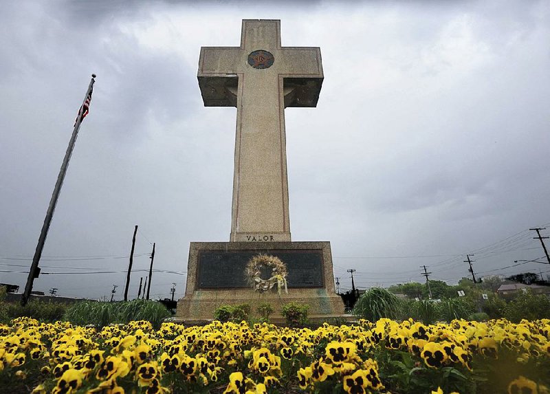 In this 2014 file photo, the World War I memorial cross is pictured in Bladensburg, Md. The Supreme Court has agreed to consider whether a nearly 100-year-old, cross-shaped war memorial on a Maryland highway median violates the Constitution’s required separation of church and state. The Baltimore Sun via 