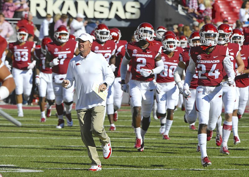 Arkansas coach Chad Morris runs onto the field before playing Vanderbilt in an NCAA college football game Saturday, Oct. 27, 2018, in Fayetteville, Ark. (AP Photo/Michael Woods)
