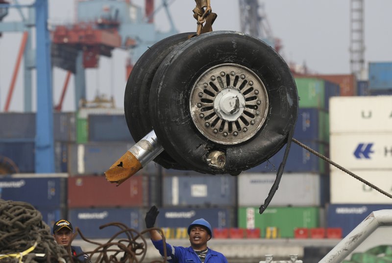 FILE - In this Saturday, Nov. 3, 2018, file photo, a crane moves a pair of wheels recovered from the Lion Air jet that crashed into the Java Sea for further investigation at Tanjung Priok Port in Jakarta, Indonesia. Boeing Co. says it has issued a safety bulletin that reiterates guidelines on how pilots should respond to erroneous data from an &quot;angle of attack&quot; sensor following last week's crash of a Boeing plane in Indonesia that killed 189 people. (AP Photo/Achmad Ibrahim, File)