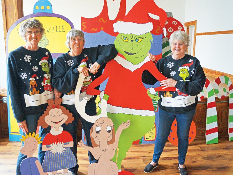 Sisters, from left, Linda Jennings; Renee Garr, mayor of Russell; and Brenda Poole, councilwoman, stand with some of the many wooden cutouts they and volunteers made to create Whoville in the tiny community. The scenes will be displayed in Larry Jennings Park, named for Linda’s late husband. A Who Feast is scheduled for 5 p.m. Dec. 6 at the former Russell school to raise money to expand the decorations next year.