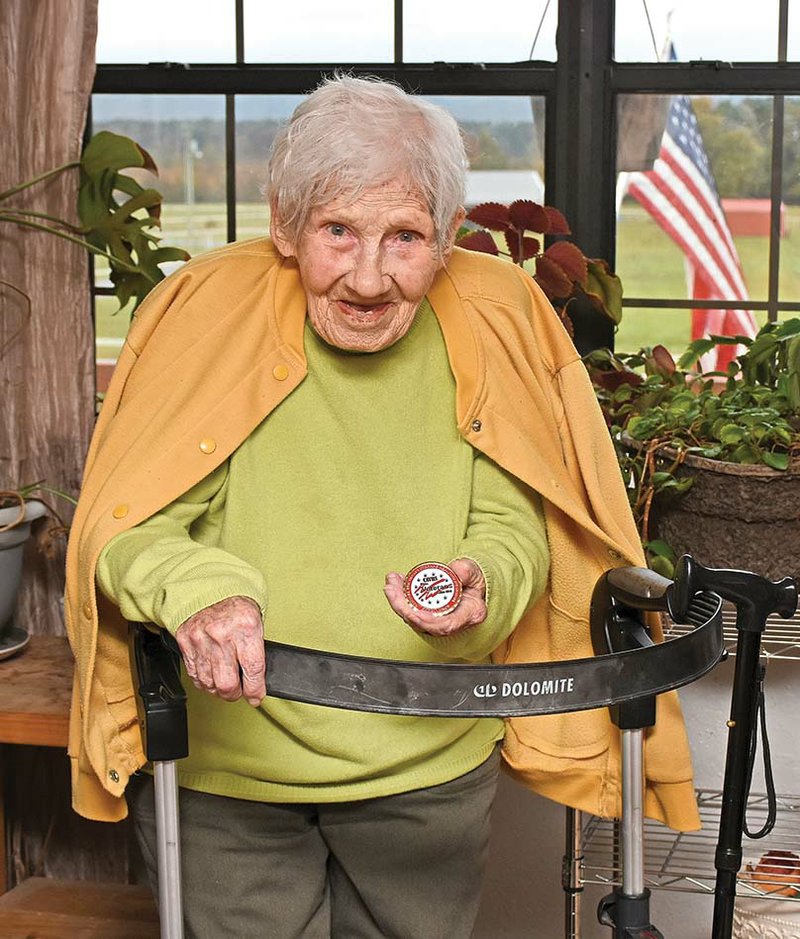 Lorine Cochran Wolf, 96, shows the commemorative coin she received recently from the Central Arkansas Veterans Health Care System, where she receives medical care. Cochran served as an Army nurse in the Philippines and Japan during World War II and later as a nurse anesthetist in the Air Force, with a tour of duty in England.

