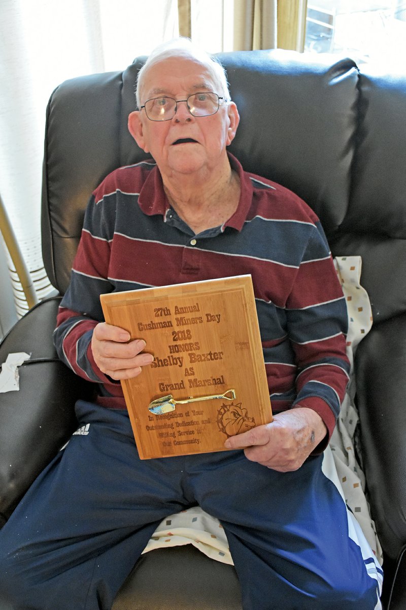 Shelby Baxter, 87, of Batesville shows the plaque he received for serving as parade marshal in this year’s Cushman Miners Day celebration. Both of his grandfathers worked in the manganese mines near Cushman. Baxter was born in Cushman and joined the Navy in 1951.
