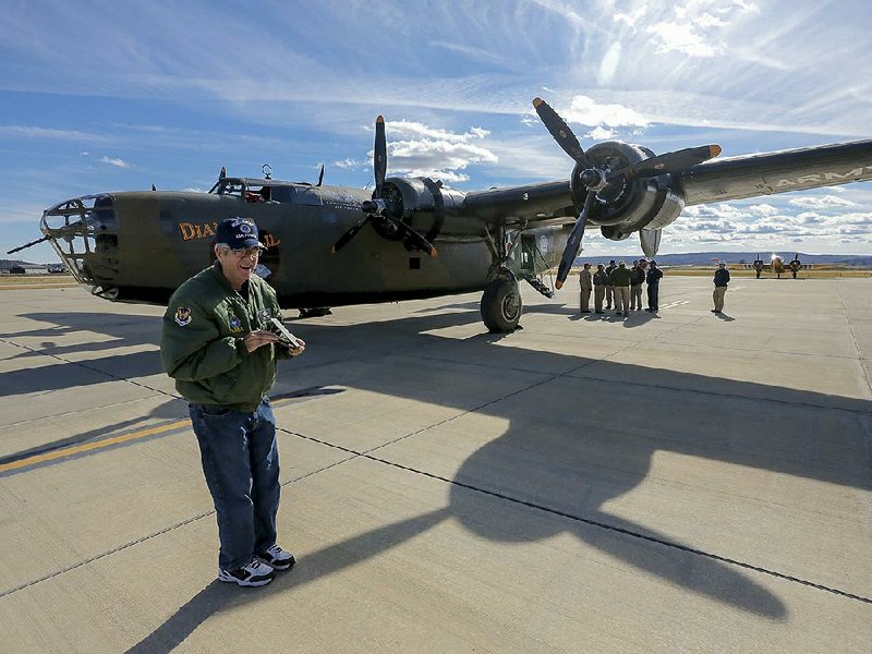 Air Force veteran Tom Newman of Conway takes a photo of a World War II-era heavy bomber, a B-24 Liberator named Diamond Lil, after the aircraft’s arrival Friday at Cantrell Field. The Commemorative Air Force AirPower History Tour will be at the Conway airport from 9 a.m. to 5 p.m. today and Sunday. The B-24 and other World War II-era planes will be display and will be available for rides and tours.  
