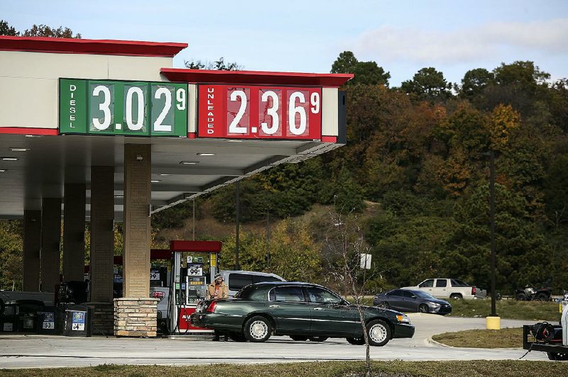 Motorists fuel up Friday at the Murphy Express on West Pershing Boulevard in North Little Rock as U.S. gasoline prices continue their slow fall.
