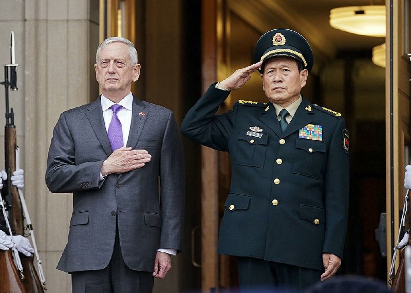 Defense Secretary James Mattis and Chinese Defense Minister Wei Fenghe stand Friday as their countries’ national anthems are played at a welcoming ceremony at the Pentagon before their talks. 