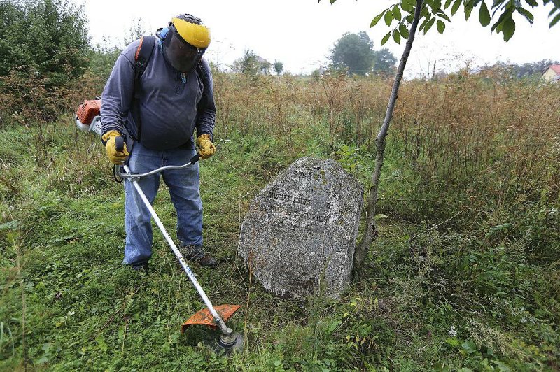 Steven Reece, an ordained Southern Baptist minister who lives near Atlanta, cleans an old Jewish cemetery in Rohatyn, the site of a Jewish Heritage project, close to Lviv, Ukraine. For years now, Reece, an ordained Southern Baptist minister from Texas, has been cleaning Jewish cemeteries and erecting memorial plaques at mass grave sites in Poland, and recently Ukraine. 