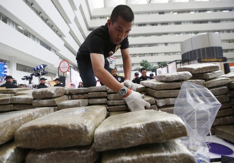 FILE - In this April 3, 2018, file photo, police pack away seized marijuana after a press conference in Bangkok, Thailand. The National Legislative Assembly on Friday, Nov. 9, submitted amendments that would put marijuana and the plant kratom, popular locally as a stimulant and painkiller, into a legal category that would allow for their licensed possession and distribution under regulated conditions. (AP Photo/Sakchai Lalit, File)