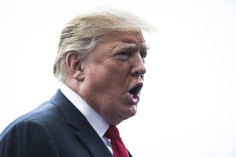 President Trump stops to talk to members of the media as he walks to board Marine One and depart from the South Lawn of the White House in October 2018. MUST CREDIT: Washington Post photo by Jabin Botsford