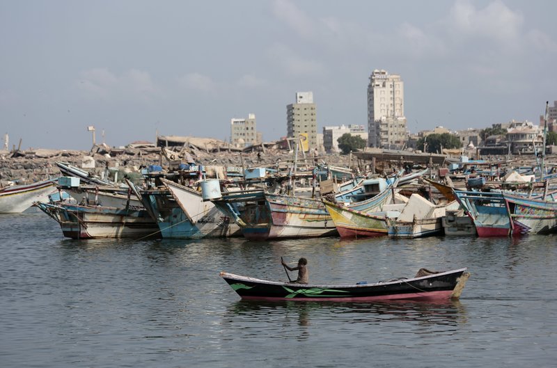 FILE - In this Friday Sept. 28, 2018 file photo, a fisherman paddles his boat past destroyed buildings on the coast of the port city of Hodeida, Yemen. Amnesty International said warned late Wednesday. Nov. 7, 2018 that Yemen's rebels have taken up positions on a hospital rooftop in the contested Red Sea city of Hodeida that a Saudi-led coalition is trying to capture. This raises concerns the Shiite rebels, known as Houthis, plan to use the patients at the Hodeida hospital as human shields to ward off airstrikes from the coalition. Amnesty is urging the warring sides to protect civilians. (AP Photo/Hani Mohammed, File)