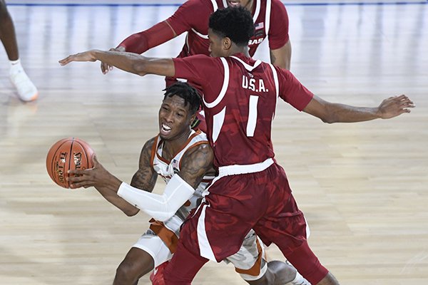 Texas' Kerwin Roach is double teamed by Arkansas' Isaiah Joe (1) and Daniel Gafford (10) during a game Friday, Nov. 9, 2018, in El Paso, Texas. 