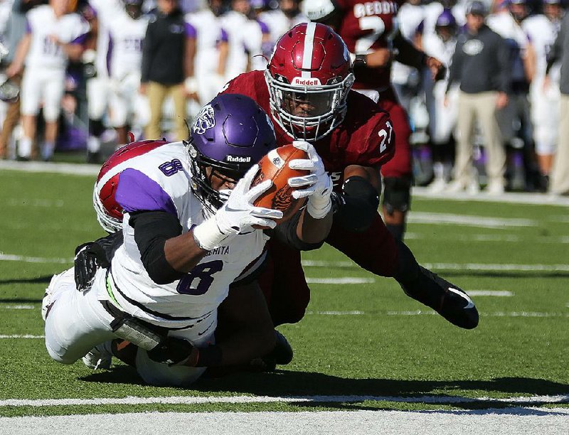 Ouachita Baptist wide receiver La’Darius McElroy lunges across  the goal line for a touchdown as he is brought down by Henderson  State defensive back Malik Brown during the second quarter of  the Tigers’ 38-10 victory Saturday at Carpenter-Haygood Stadium in Arkadelphia.