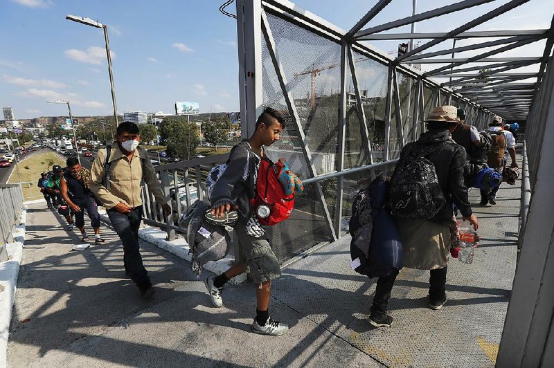 Central American migrants arrive Saturday in Queretaro, Mexico.