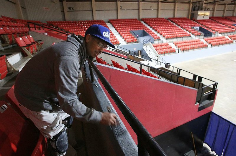 Marcus McCoy paints the railing Thursday at the Pine Bluff Convention Center, which will host the King Cotton Classic tournament. The center is undergoing $540,000 in renovations, paid for by the Pine Bluff Urban Renewal Agency.