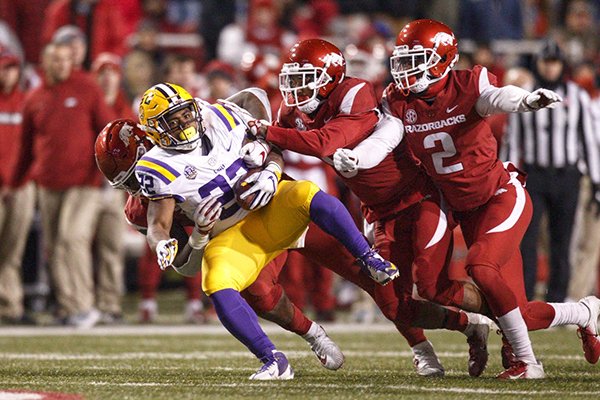 Arkansas defenders tackle LSU running back Clyde Edwards-Helaire during a game Saturday, Nov. 10, 2018, in Fayetteville. 