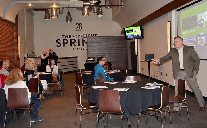 Hunter McFerrin/Siloam Sunday Downtown small business owners gathered at the 28 Springs Banquet Room on Thursday morning for a breakfast of biscuits and gravy and the last "Invigorate" seminar of 2018. Hosted by Main Street Siloam Springs, the seminars have been geared toward offering tips and advice to business owners downtown that could help to improve the quality of their businesses. This seminar was aimed at providing information relating to methods business owners can use to improve security for their employees and merchandise. Capt. Derek Spicer, City Communications Officer Deandra Strickland and Police Chief Jim Wilmeth of the Siloam Springs Police Department helped to facilitate this and gave a brief presentation that was followed by group discussion and opportunity for those attending to ask questions. Chief Wilmeth (right) explains a program the SSPD is now offering called "Project Stronghold," in which business owners can request a free threat assessment from the department, who will then send out an officer to evaluate the efficacy of certain security mechanisms, ranging from alarm systems to the quality of exterior doors. Business owners interested in the program are encouraged to call the SSPD at 479-524-4118.