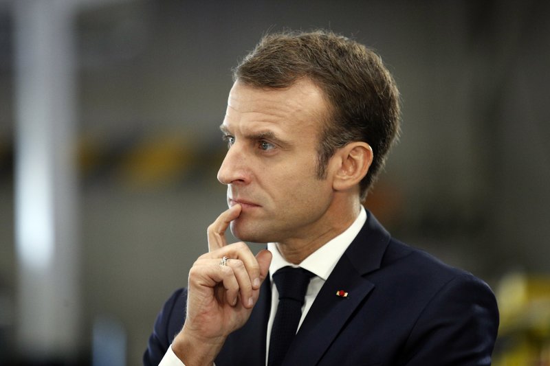French President Emmanuel Macron listens to workers inside the French carmaker Renault factory of Maubeuge, northern France, Thursday, Nov.8, 2018. (AP Photo/Francois Mori)
