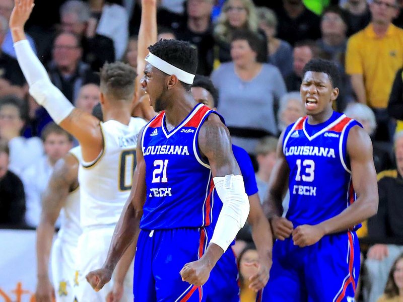 Submitted photo SHOCKER AWE: Louisiana Tech's Exavian Christon (21) and Stacey Thomas (13) celebrate Tuesday during the Bulldogs' 71-58 road win against the Shockers at Charles Koch Arena in Wichita, Kansas. Photo by Steve Adelson, courtesy of Wichita State Athletics.