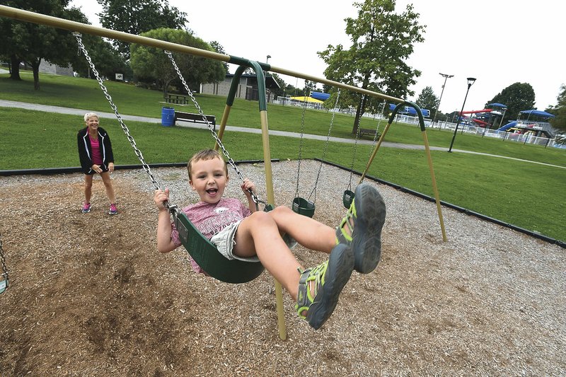 File photo/NWA Democrat-Gazette/J.T. WAMPLER Elizabeth Warren of Lowell pushes her grandson Seth Warren, 4, on a swing at Springdale's Murphy Park in August. The City Council will begin hearing budget requests for 2019. The opening of the C.L. "Charlie" and Willie George Park and the growing trail system also add maintenance responsibilities to the Parks Department.