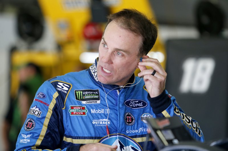  In this July 21, 2018, file photo, driver Kevin Harvick puts in an ear piece as he prepares for practice for the NASCAR Cup Series auto race at New Hampshire Motor Speedway in Loudon, N.H. 