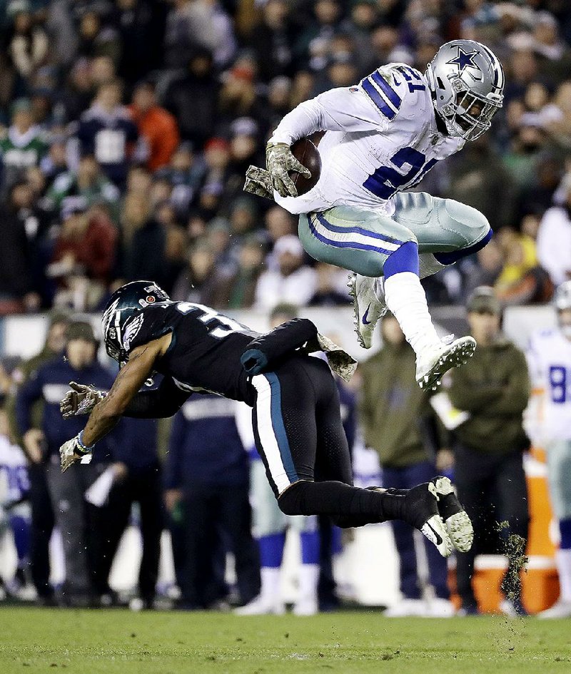 Dallas Cowboys running back Ezekiel Elliott hurdles over Philadelphia Eagles defensive back Tre Sullivan during the first half Sunday in Philadelphia. Elliott ran for 151 yards and a TD and also had 36 yards receiving and another score as Dallas won 27-20.