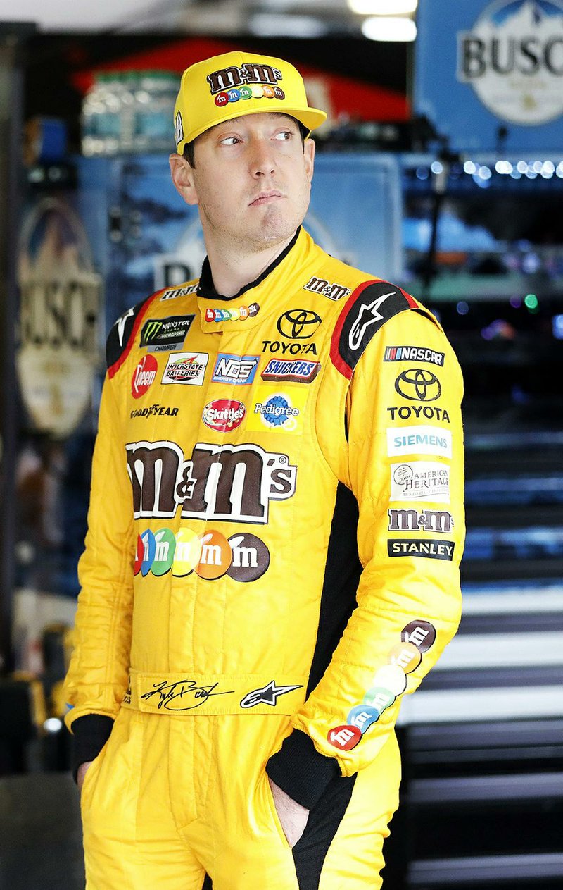 NASCAR Cup Series driver Kyle Busch stands in the garage before auto racing practice at Kansas Speedway in Kansas City, Kan., Friday, Oct. 19, 2018.