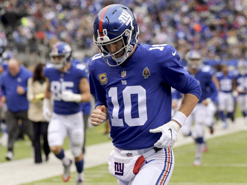 FILE - In this Oct. 28, 2018, file photo, New York Giants quarterback Eli Manning (10) runs off the field at the end of the first half of the team's NFL football game against the Washington Redskins in East Rutherford, N.J. The Giants play the San Francisco 49ers on Monday night. San Francisco quarterback Nick Mullens took part in the Manning Passing Academy two years. While Mullens is just getting started, Manning is nearing the end of his career as he plays his 15th season for a team that is struggling mightily. (AP Photo/Bill Kostroun, File)