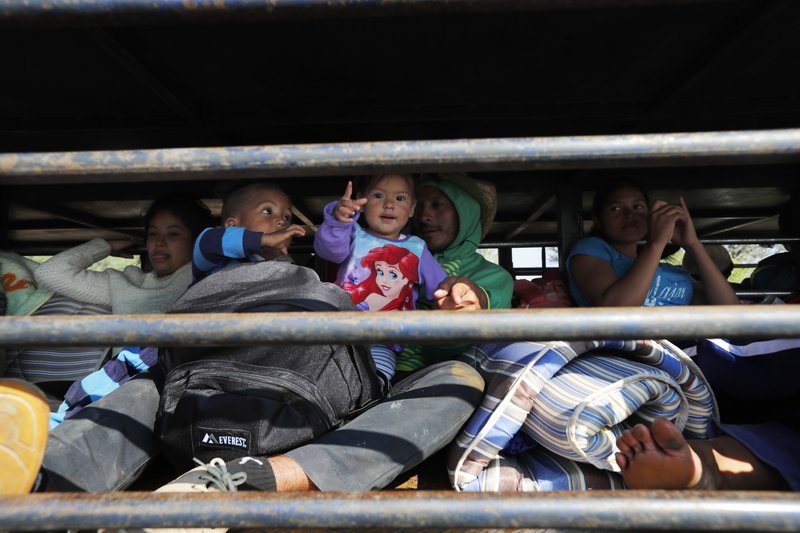 Central American migrants, part of the caravan hoping to reach the U.S. border, get a ride on a truck, in Celaya, Mexico, Sunday, Nov. 11, 2018. Local Mexican officials were once again Sunday helping thousands of Central American migrants find rides on the next leg of their journey toward the U.S. border. (AP Photo/Marco Ugarte)