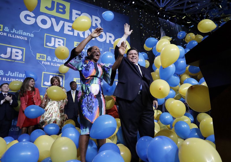 FILE - In this Tuesday, Nov. 6, 2018, file photo, Democratic gubernatorial candidate J.B. Pritzker, right, and his running mate Lt. Governor candidate Juliana Stratton celebrate as they wave to supporters after they won over Republican incumbent Bruce Rauner in Chicago. Democrats who gained new or expanded powers in state elections are gearing up for a left-leaning push on gun control, universal health care and legal marijuana. Meanwhile, some Republican legislatures that have cut taxes and limited union powers are adjusting to a new reality of needing to work with a Democratic governor. The midterm elections Tuesday, Nov. 6, increased Democratic relevance in state capitols that have been dominated by Republicans during the past decade. (AP Photo/Nam Y. Huh, File)