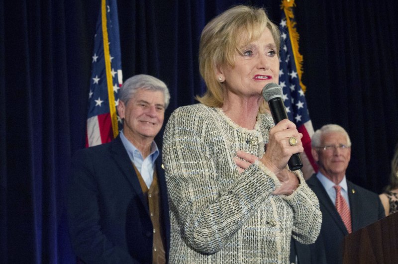 FILE — Sen. Cindy Hyde-Smith, R-Miss., speaks to supporters of her campaign during an election night party she shared with fellow Republican U.S. Sen. Roger Wicker, right, in Jackson, Miss., Tuesday, Nov. 6, 2018.  (Sarah Warnock/The Clarion-Ledger via AP)

