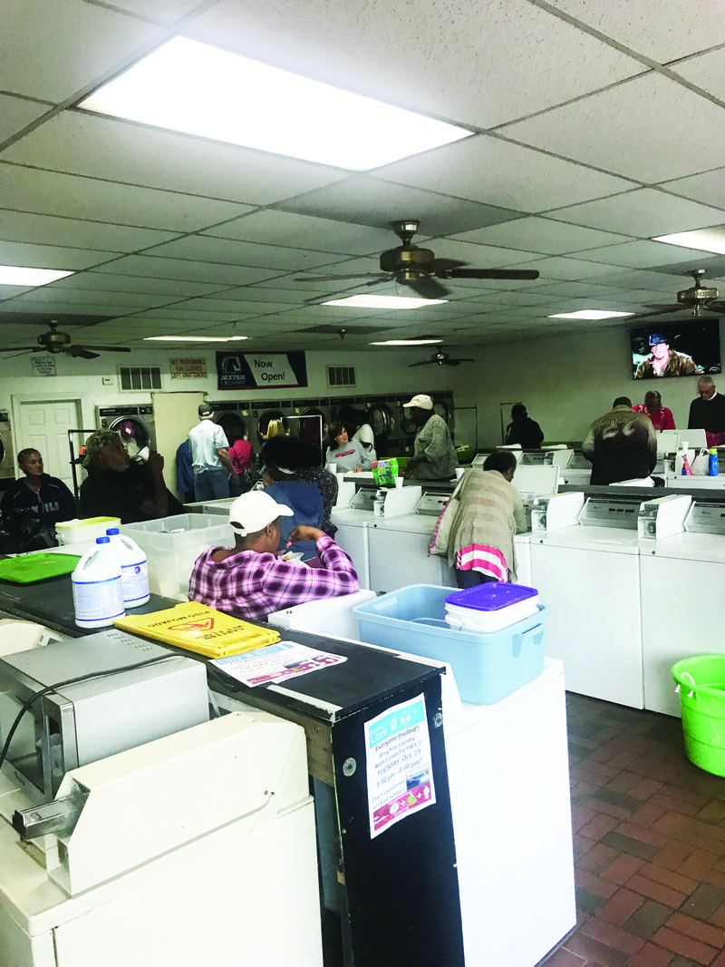  Volunteers from Immanuel Baptist Church help people with their laundry at Doe’s Laundromat on Oct. 23. As a partnership with the Salvation Army of El Dorado, Immanuel Baptist Church hosts Laundry Love every fourth Tuesday of the month at Doe’s Laundromat, where they provide free laundry for people, which includes laundry detergent, quarters for the machines and man power to help fold the laundry and take it to people’s cars. The Laundry Love program has been taking place at Doe’s Laundromat for almost seven years.