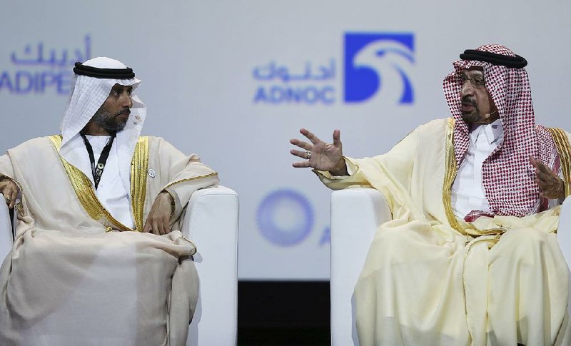 Saudi Energy and Oil Minister Khalid al-Falih (right), shown speaking to United Arab Emirates Energy Minister Suhail al-Mazrouei on Monday in Abu Dhabi, UAE, said OPEC and allied oil-producing countries should cut oil output to restore balance to the market.