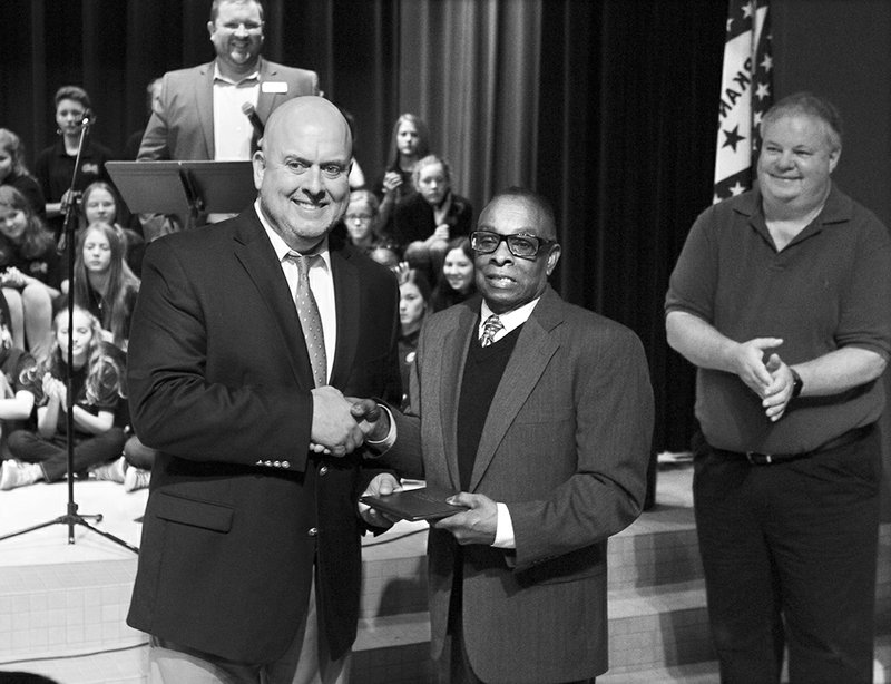 The Sentinel-Record/Richard Rasmussen HONORED GRADUATE: Lakeside Superintendent Shawn Cook, left, presents an honorary high school diploma to Lonnie L. Tidwell, a U.S. Army veteran who served in Vietnam, during a Veterans Day Ceremony at Lakeside Middle School Monday. The school honored Tidwell and Vivian Gray Erichsen with diplomas made possible by the Arkansas Department of Education Rules Governing Diplomas for Veterans.