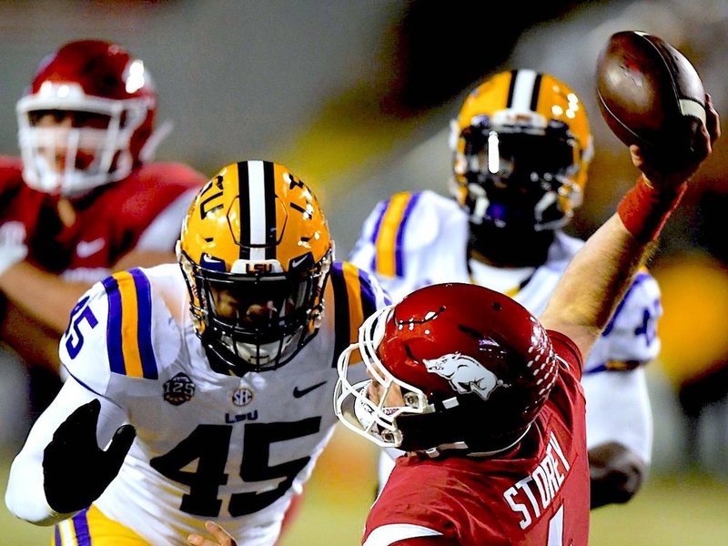 NWA Democrat-Gazette/Charlie Kaijo DIVINE INTERVENTION: LSU linebacker Michael Divinity Jr. (45) pressures Arkansas quarterback Ty Storey (4) during the Tigers' 24-17 win over the Razorbacks Saturday at Donald W. Reynolds Razorback Stadium in Fayetteville.