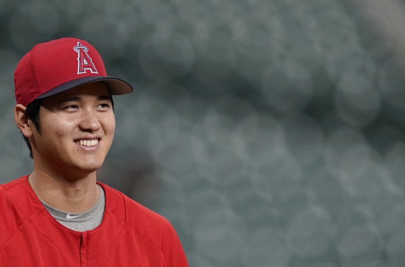 In this Sept. 21, 2018 photo Los Angeles Angels' Shohei Ohtani, of Japan, waits to stretch during batting practice before a baseball game against the Houston Astros in Houston. Ohtani has been voted American League Rookie of the Year after becoming the first player since Babe Ruth with 10 homers and four pitching wins in the same season. Ohtani, a 24-year-old right-hander who joined the Angels last winter after five seasons with Japan's Nippon Ham Fighters, received 25 first-place votes and four seconds for 137 points from the Baseball Writers' Association of America in balloting announced Monday, Nov. 12, 2018. (AP Photo/David J. Phillip)