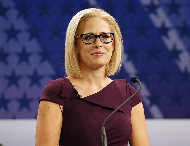 FILE - In this Oct. 15, 2018 file photo, U.S. Rep. Kyrsten Sinema, D-Ariz., goes over the rules in a television studio prior to a televised debate with U.S. Rep. Martha McSally, R-Ariz., in Phoenix. Sinema won Arizona's open U.S. Senate seat Monday, Nov. 12, in a race that was among the most closely watched in the nation, beating Republican Rep. Martha McSally in the battle to replace GOP Sen. Jeff Flake. (AP Photo/Matt York, File)