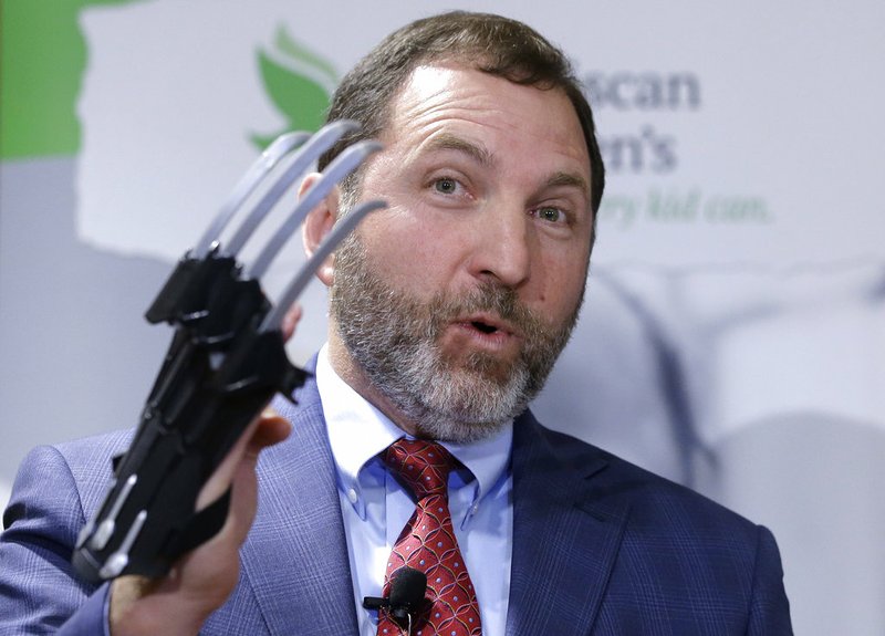 James Swartz, director of the Massachusetts-based consumer safety group World Against Toys Causing Harm, or W.A.T.C.H., displays a Black Panther "slash claw" as he introduces toys topping the group's annual list of worst toys for the holiday season, during a news conference, Tuesday, Nov. 13, 2018, at a hospital, in Boston. The group says the Black Panther "slash claw" has the potential for eye and facial injuries. (AP Photo/Steven Senne)