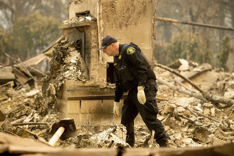 Alameda County Sheriff's deputy A. Gogna searches for victims on Monday, Nov. 12, 2018. (AP Photo/Noah Berger)

