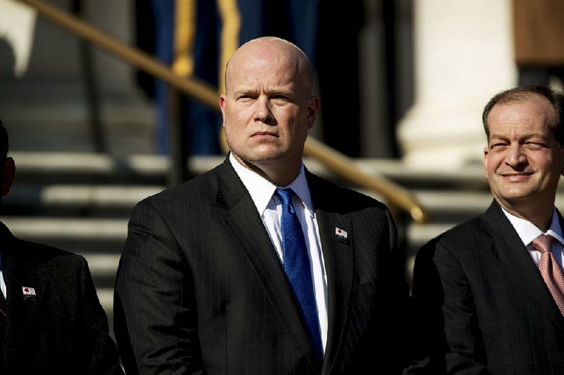 Acting United States Attorney General Matt Whitaker, center, and Labor Secretary Alex Acosta, right, attend a wreath laying ceremony at the Tomb of the Unknown Soldier during a ceremony at Arlington National Cemetery on Veterans Day, Sunday, Nov. 11, 2018 in Arlington, Va. 