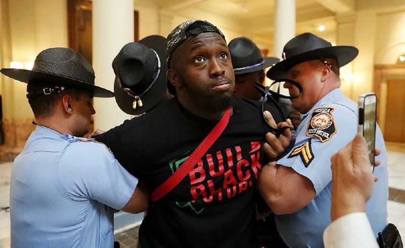 Georgia state troopers arrest a man Tuesday in the state Capitol  in Atlanta during a protest over election ballot counts. 